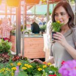 woman looking to pick the right plant for the right place but checking the fragrance first